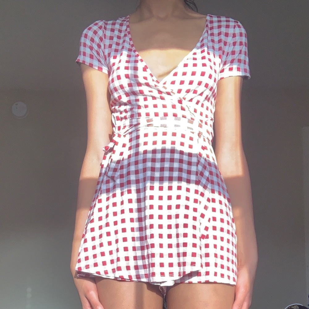 A red and white checker board print romper